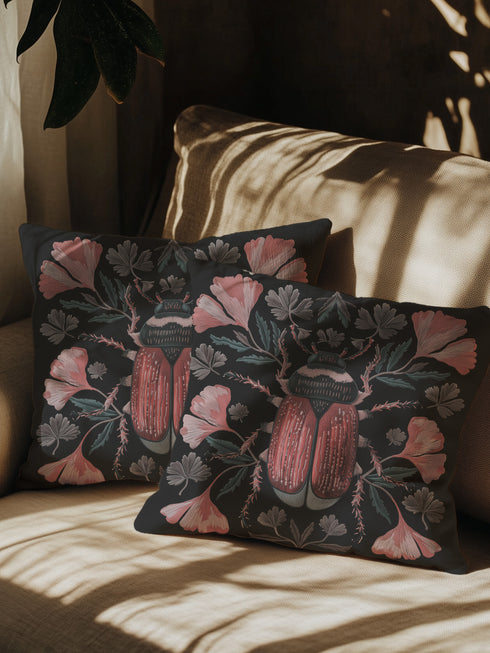 Elegant black pillowcase featuring detailed coral-red beetle illustration centered amid symmetrical pink flowers and gray-green foliage. The dark background enhances the intricate entomology artwork with fine detailing throughout the botanical and insect elements.